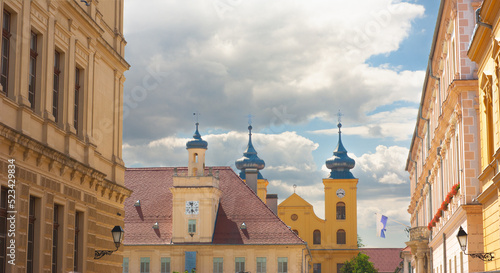 Vászonkép Osijek Street scene near Citadel in Croatia with St Michael Church in background with blue skies and clouds above
