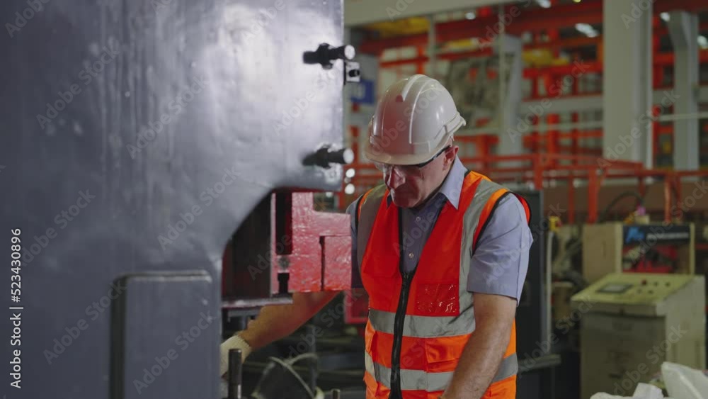 Professional industrial, Man workers working on machines, Heavy Industry, Men wearing safety uniforms and hard hats are 48-year-old. Professional industrial, Man workers working on machines, Heavy Industry, Men wearing safety uniforms and hard hats are 48-year-old.