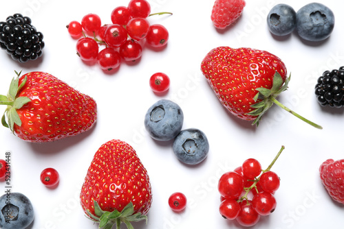 Mix of fresh berries on white background, flat lay