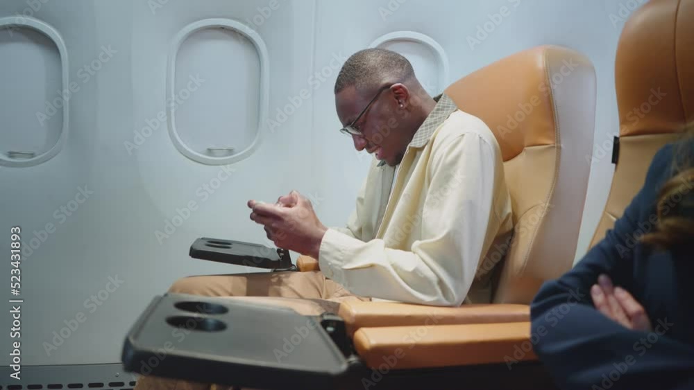 Man playing the game online on a smartphone during traveling on a plane. slow motion Man playing the game online on a smartphone during traveling on a plane. slow motion