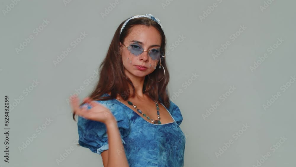 Portrait of seductive pretty young woman in blue princess dress wearing sunglasses, charming smile. Adult stylish female girl isolated alone on gray studio background indoors. People emotions concept Portrait of seductive pretty young woman in blue princess dress wearing sunglasses, charming smile. Adult stylish female girl isolated alone on gray studio background indoors. People emotions concept