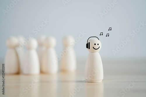 Introvert Person. Individuality. Unique. Person who Happy and Enjoy by Solitude, Spent Time alone. Wooden figure happy with listen music alone among many crowd. Psychology Personality Concept.