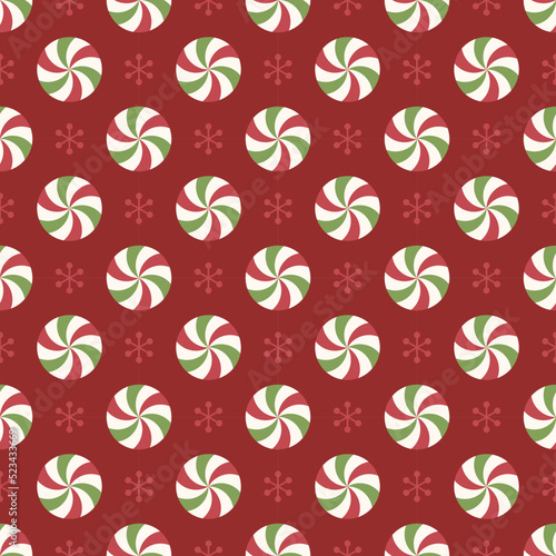 Seamless pattern with red and green peppermint candies and snowflakes.