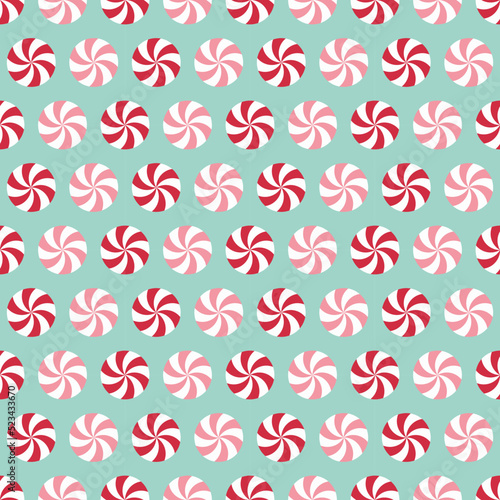 Seamless pattern with peppermint candies. Red and pink mint candies on light blue background.