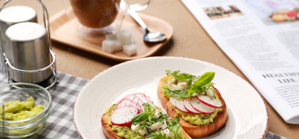 Plate with tasty sandwiches on table, closeup