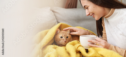 Woman with cute red cat dri...