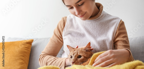 Woman with cute red cat at ...