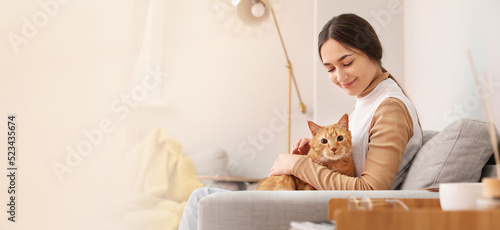 Woman with cute red cat sit...