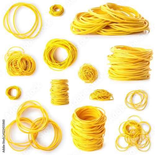 Collection of yellow elastic bands on white background