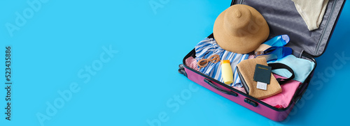 Open suitcase with clothes ...