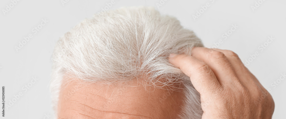 Senior man with grey hair on light background, closeup Senior man with grey hair on light background, closeup