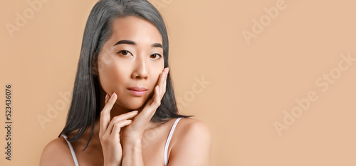 Asian woman with graying ha...