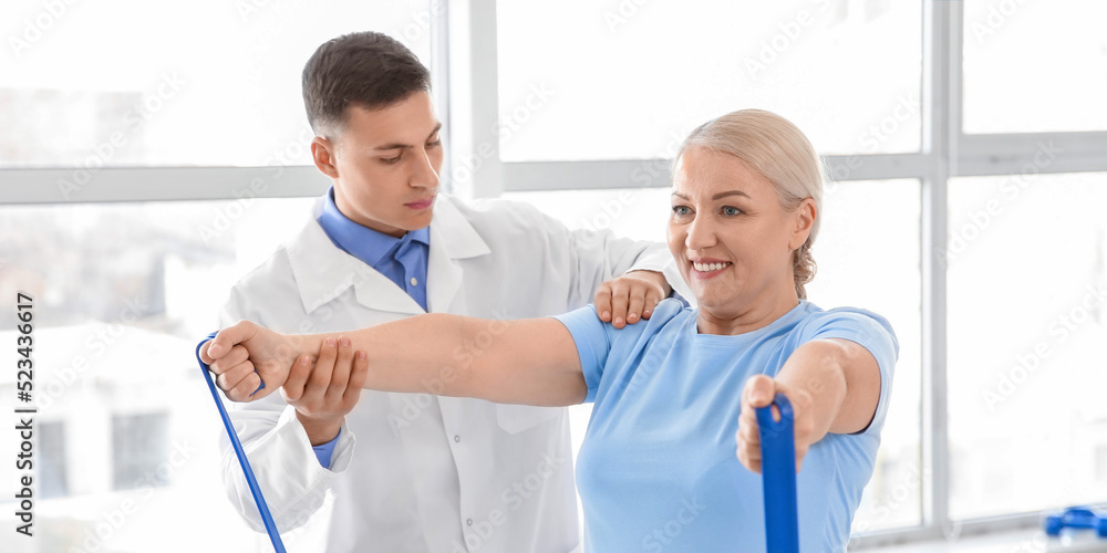 Physiotherapist working with mature patient in rehabilitation center Physiotherapist working with mature patient in rehabilitation center
