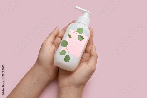 Female hands with bottle of...