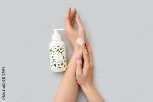 Woman applying cosmetic cre...