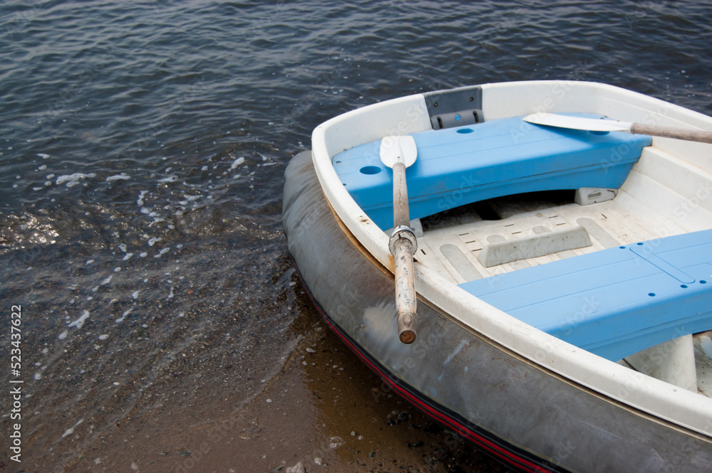 Empty inflatable boat with oars