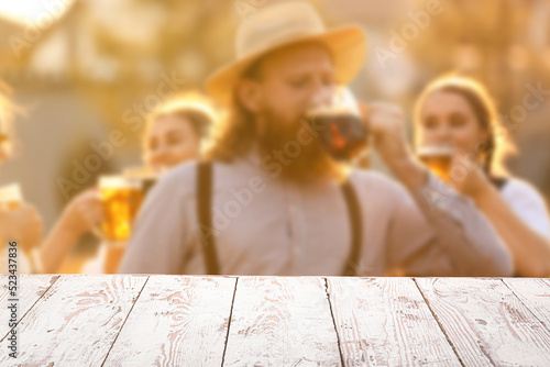 Empty wooden table and youn...