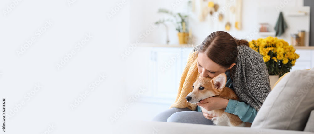 Young woman with cute Corgi dog at home. Banner for design Young woman with cute Corgi dog at home. Banner for design