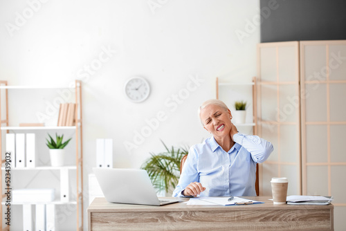 Mature businesswoman suffer...