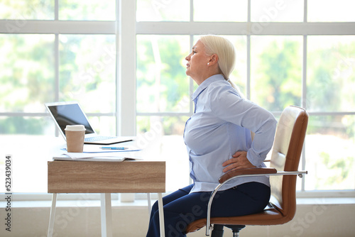 Mature businesswoman suffer...