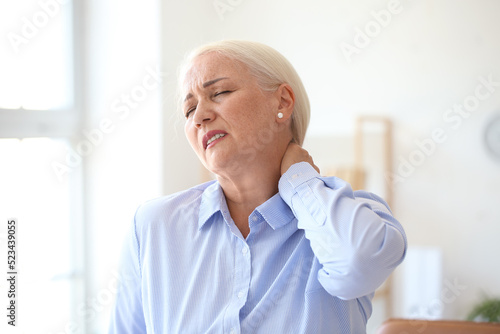 Mature businesswoman suffer...