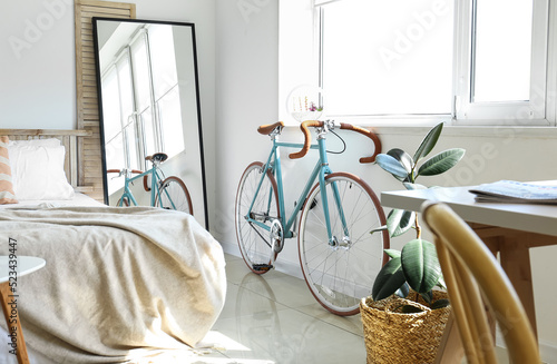 Modern bicycle near window ...
