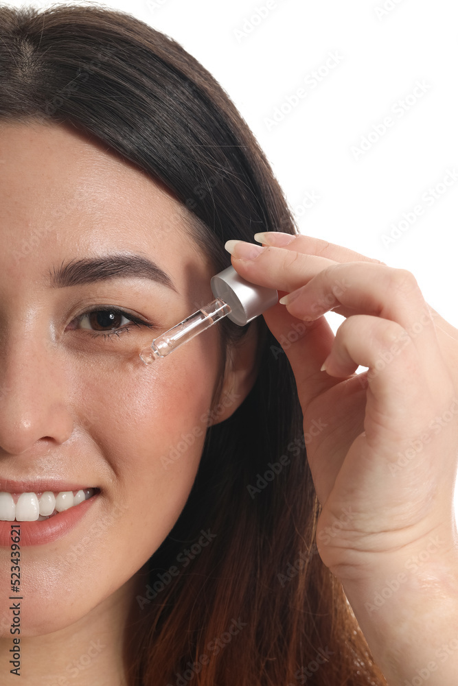 Young Asian woman with cosmetic serum isolated on white, closeup Young Asian woman with cosmetic serum isolated on white, closeup