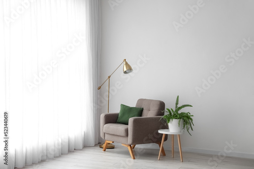 Table with houseplant, armc...