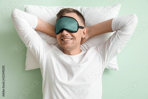 Young man with sleeping mas...