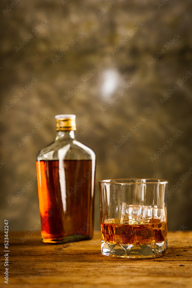 Wiskey in a glass with the ice cubes on the reflective black surface. Bar drinking menu Wiskey in a glass with the ice cubes on the reflective black surface. Bar drinking menu