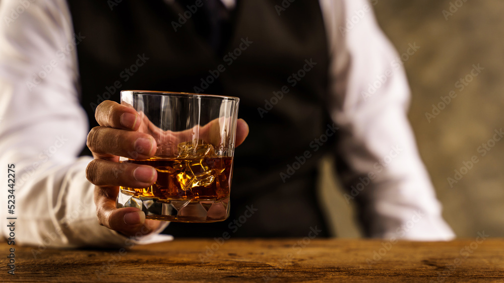 Barman pouring wiskey whiskey glass and giving.