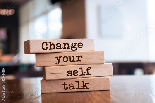 Wooden blocks with words 'Change your self talk'. photo