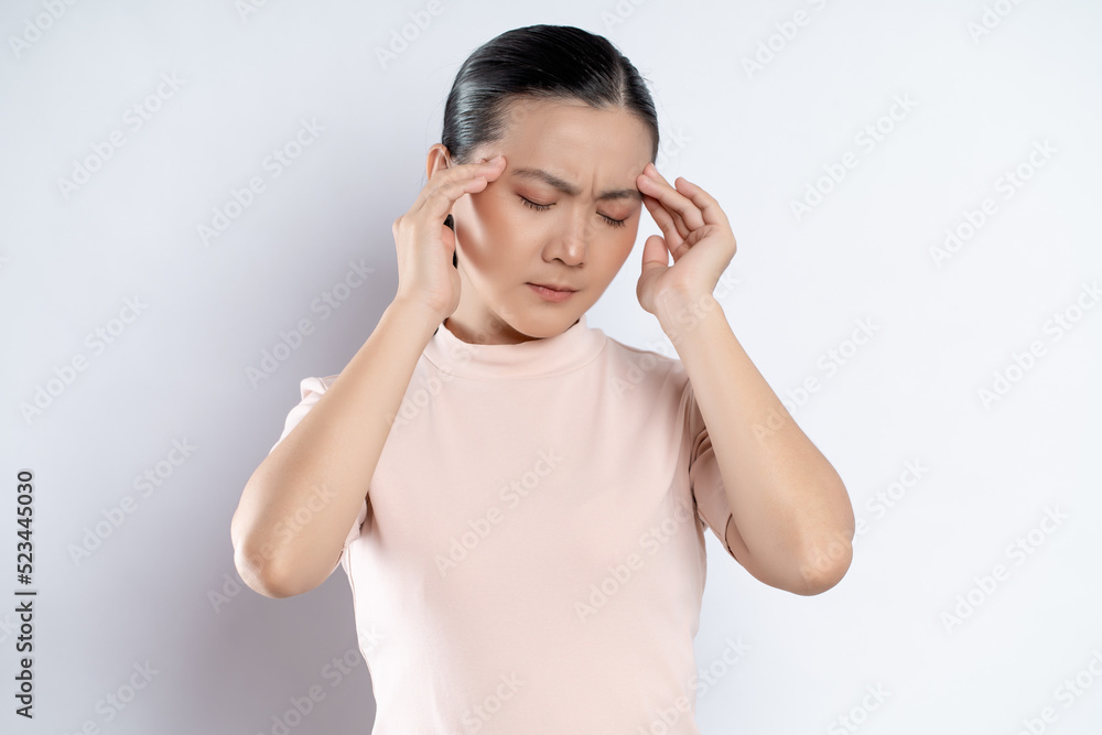 Asian woman was sick with headache standing isolated on white background. Asian woman was sick with headache standing isolated on white background.