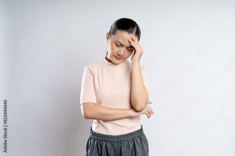 Asian woman was sick with headache standing isolated on white background. Asian woman was sick with headache standing isolated on white background.