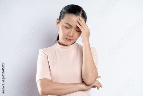 Asian woman was sick with headache standing isolated on white background.