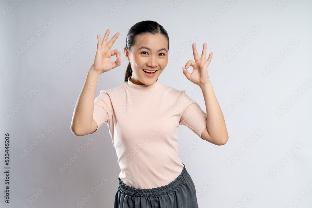 Happy woman showing OK gesture isolated on background. Happy woman showing OK gesture isolated on background.