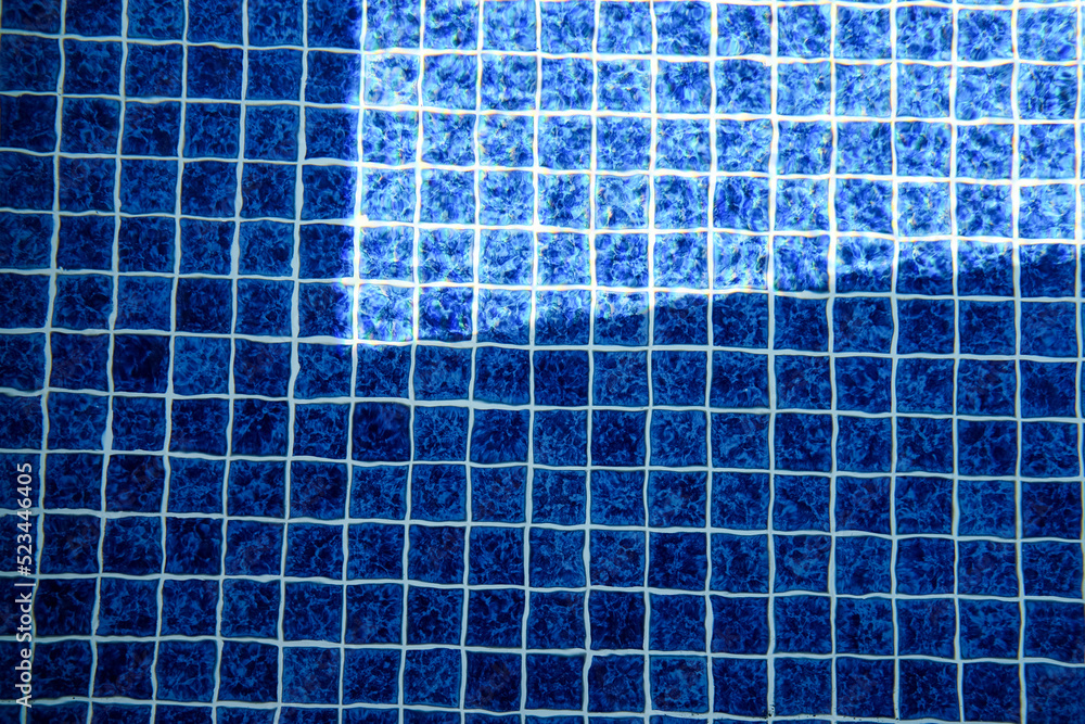 abstract background. swimming pool base. blue tiles on the bottom of a pool full of water abstract background. swimming pool base. blue tiles on the bottom of a pool full of water