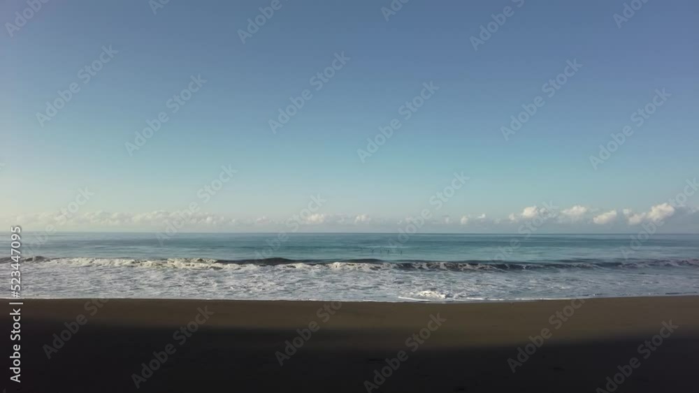 Seagulls passing by over waves crushing in the ocean Seagulls passing by over waves crushing in the ocean