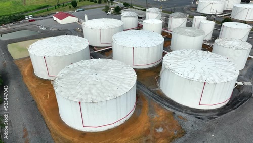 Bulk fuel storage tanks at terminal in USA. Oil, gas, home heating oil. Aerial reveal. photo