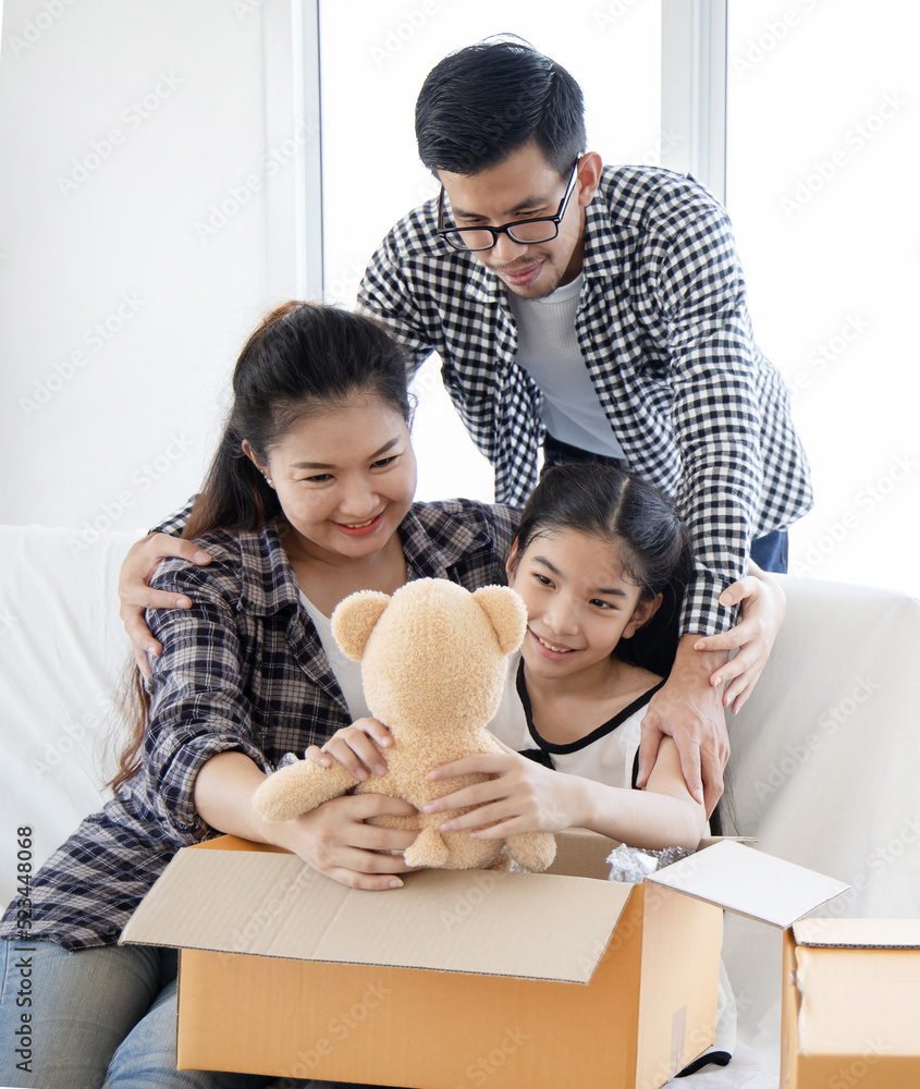Happy Asian Family Moving the boxes to a new home,Moving concept Happy Asian Family Moving the boxes to a new home,Moving concept