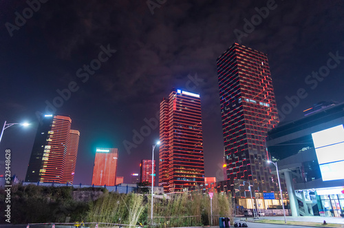Illuminated modern office buildings in downtown district of Shenzhen city, China