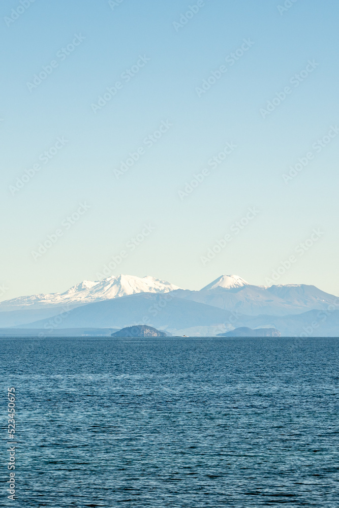 Snow capped peaks of Mt Ruapehu across Lake Taupo in New Zealand's North island