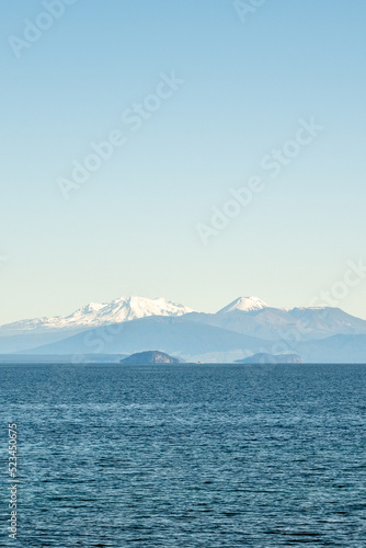 Snow capped peaks of Mt Ruapehu across Lake Taupo in New Zealand s North island