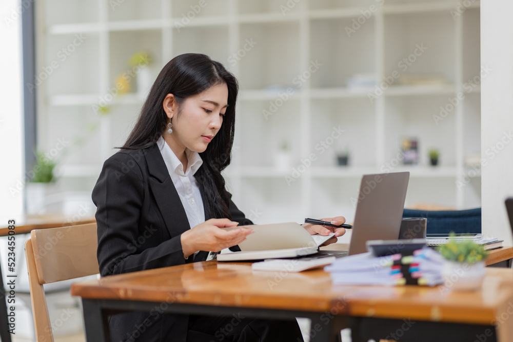 Business Asian woman working with laptop computer and calculator document on an office desk, doing planning analyzing the financial report, business plan investment, finance analysis concept.
Business Asian woman working with laptop computer and calculator document on an office desk, doing planning analyzing the financial report, business plan investment, finance analysis concept.