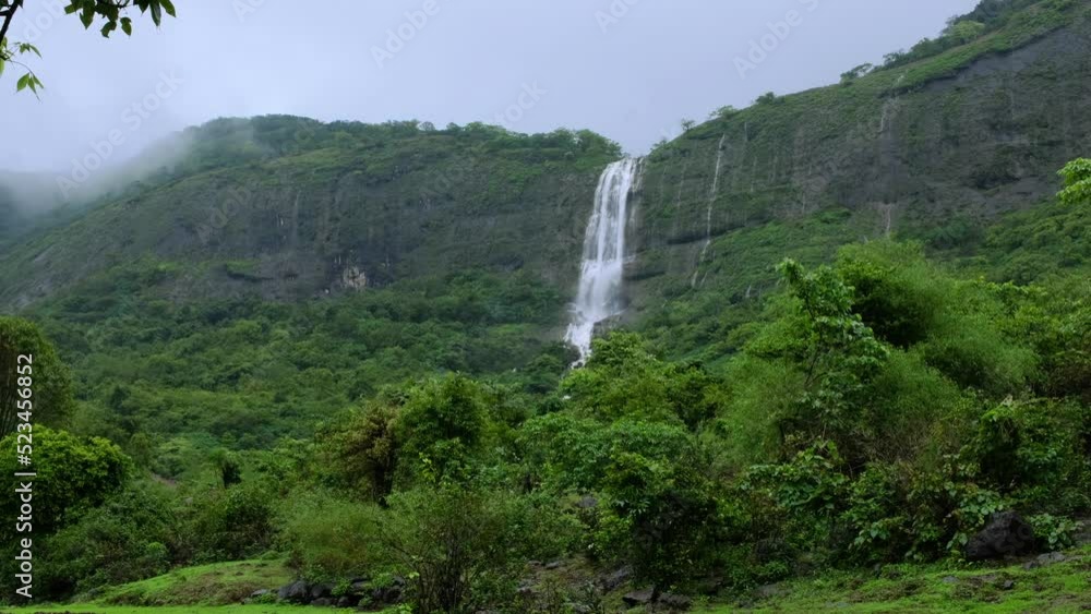 Lush green landscape with waterfalls in full flow during the monsoon ...