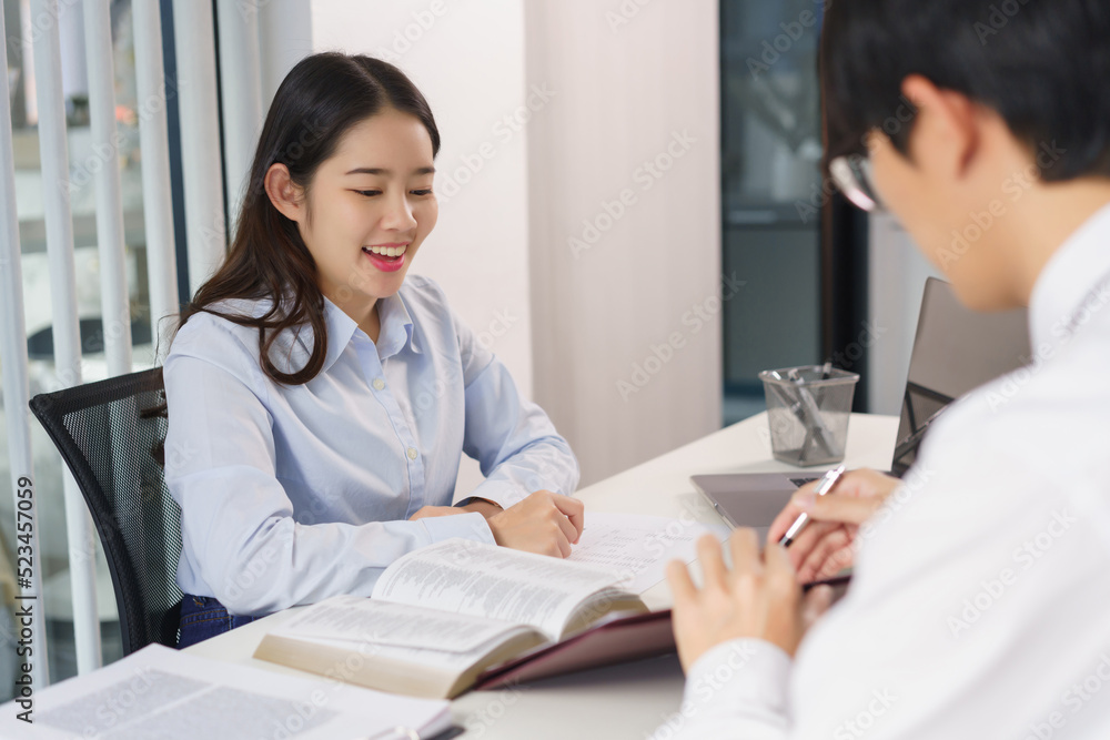 Business concept, Two business colleague pointing on document to explaining investment in project Business concept, Two business colleague pointing on document to explaining investment in project