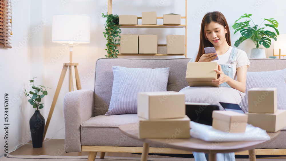 Online seller concept, Female entrepreneur use smartphone to take a picture parcel boxes to client Online seller concept, Female entrepreneur use smartphone to take a picture parcel boxes to client