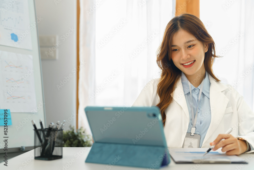 Successful business concept, Businesswoman reading financial report on tablet and taking note data Successful business concept, Businesswoman reading financial report on tablet and taking note data