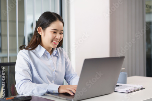Business concept, Businesswoman researching and checking of marketing data on laptop in office