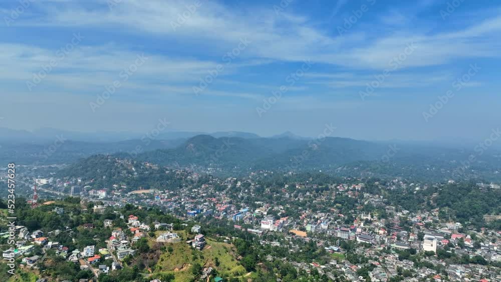 Aerial Panning Shot Of Residential Buildings In City Amidst Mountains, Drone Flying On Sunny Day - Kandy, Sri Lanka Aerial Panning Shot Of Residential Buildings In City Amidst Mountains, Drone Flying On Sunny Day - Kandy, Sri Lanka